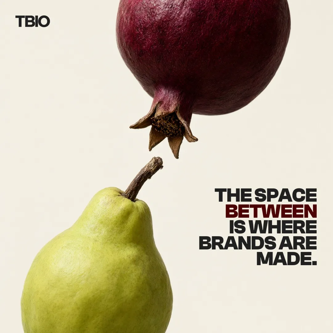 A pomegranate and a pear almost touching, with the line THE SPACE BETWEEN IS WHERE BRANDS ARE MADE.