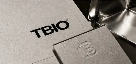 Blind-debossed TBIO card on grey paper.